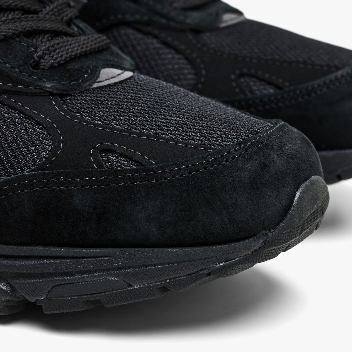 New Balance Made In USA 993. Close-up front view showcasing premium black suede mudguard overlay and breathable mesh toe box paneling. 