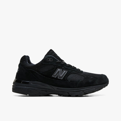 New Balance Made In USA 993. Profile view featuring all-black suede and mesh upper, tonal black 'N' logo, and cushioned ABZORB DTS midsole. 