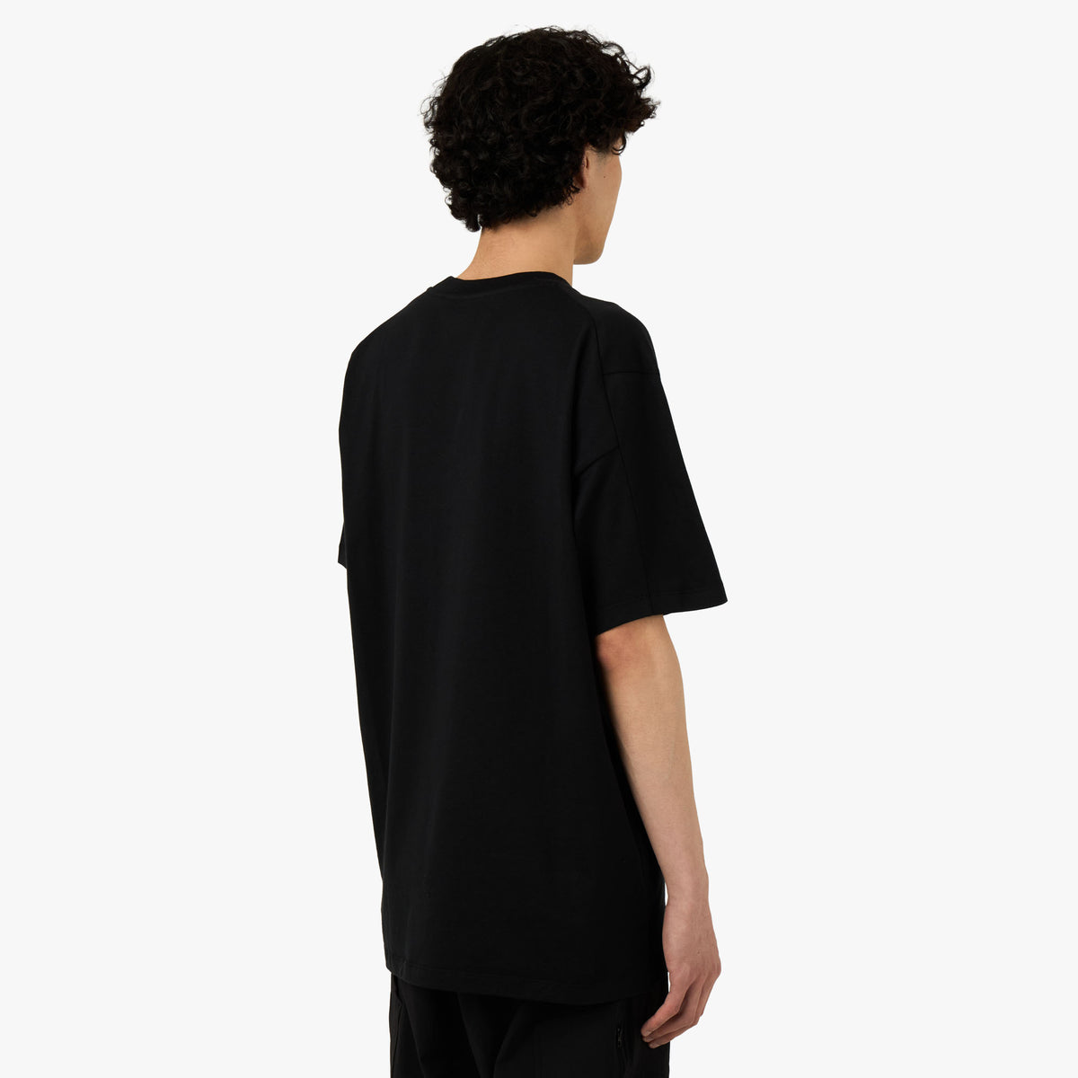 Arc'teryx Kragg SL Cotton T-Shirt. Rear model view showing plain black body, shortsleeves, and clean hem finish. 