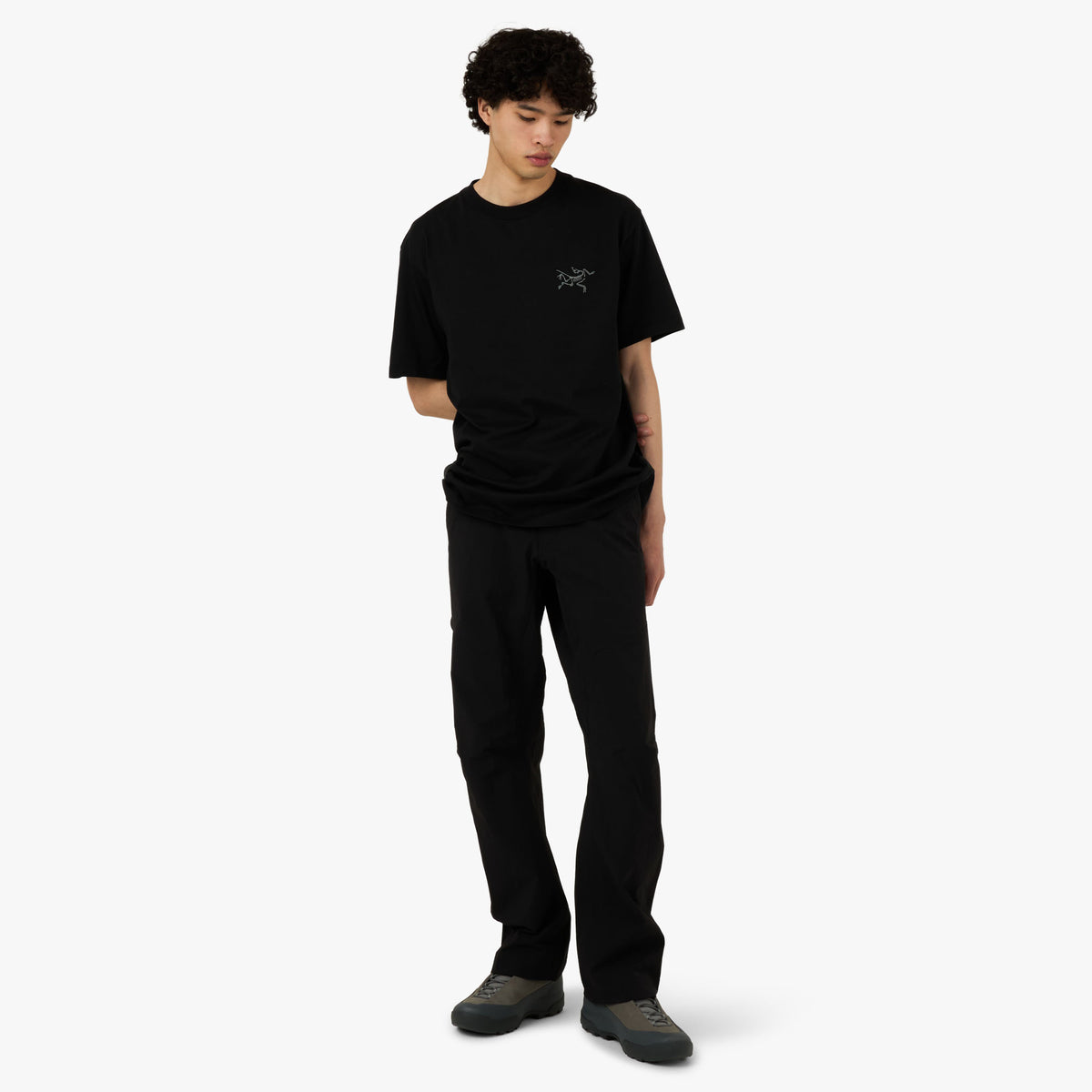 Arc'teryx Kragg SL Cotton T-Shirt. Full-length model view showcasing the relaxed silhouette of the black t-shirt. 