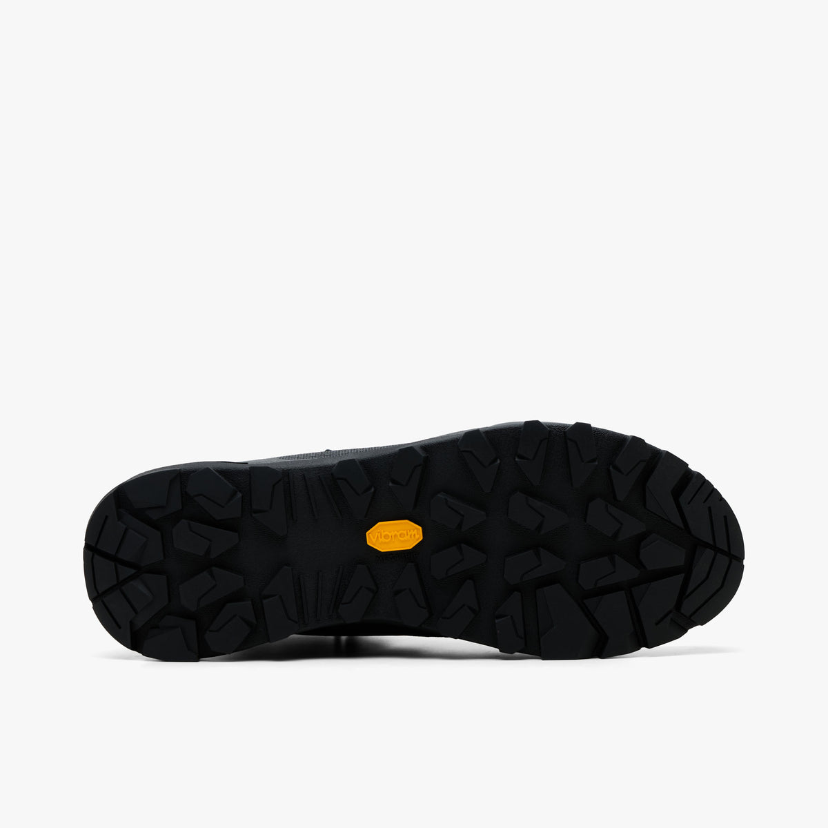 Arc'teryx Konseal Trek. Bottom view of single boot displaying full black Vibram Megagrip rubber outsole with deep multidirectional lugs and yellow Vibram logo badge. 
