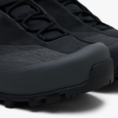 Arc'teryx Konseal Trek. Close-up view of toe box highlighting breathable dark graphite mesh vamp, reinforced protective TPU toe rand overlay, and front outsole wrapped tip. 